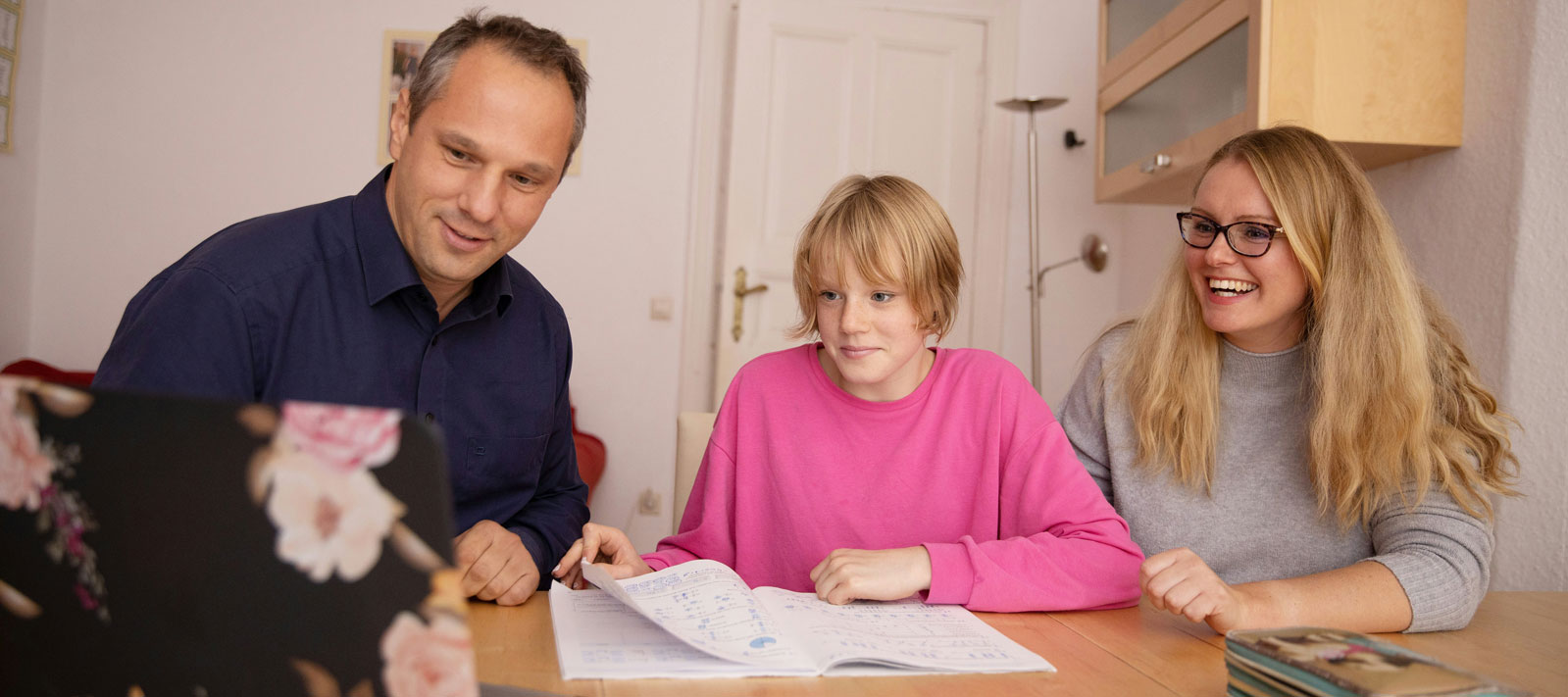 Student and parents in dorm room